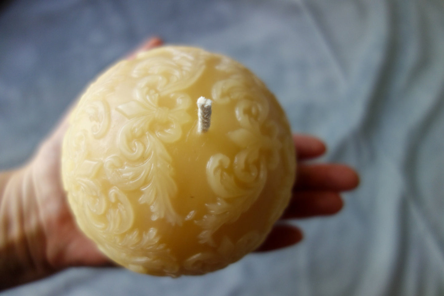 Beeswax ball candle with fleur-de-lis pattern